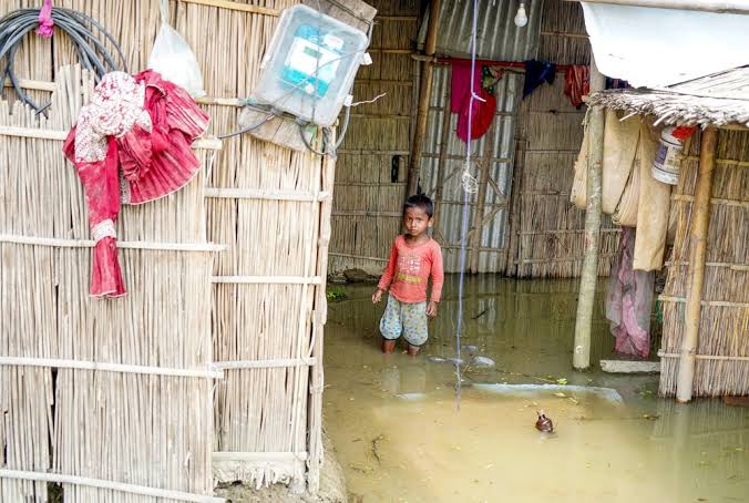 A flood-affected bamboo home in Assam