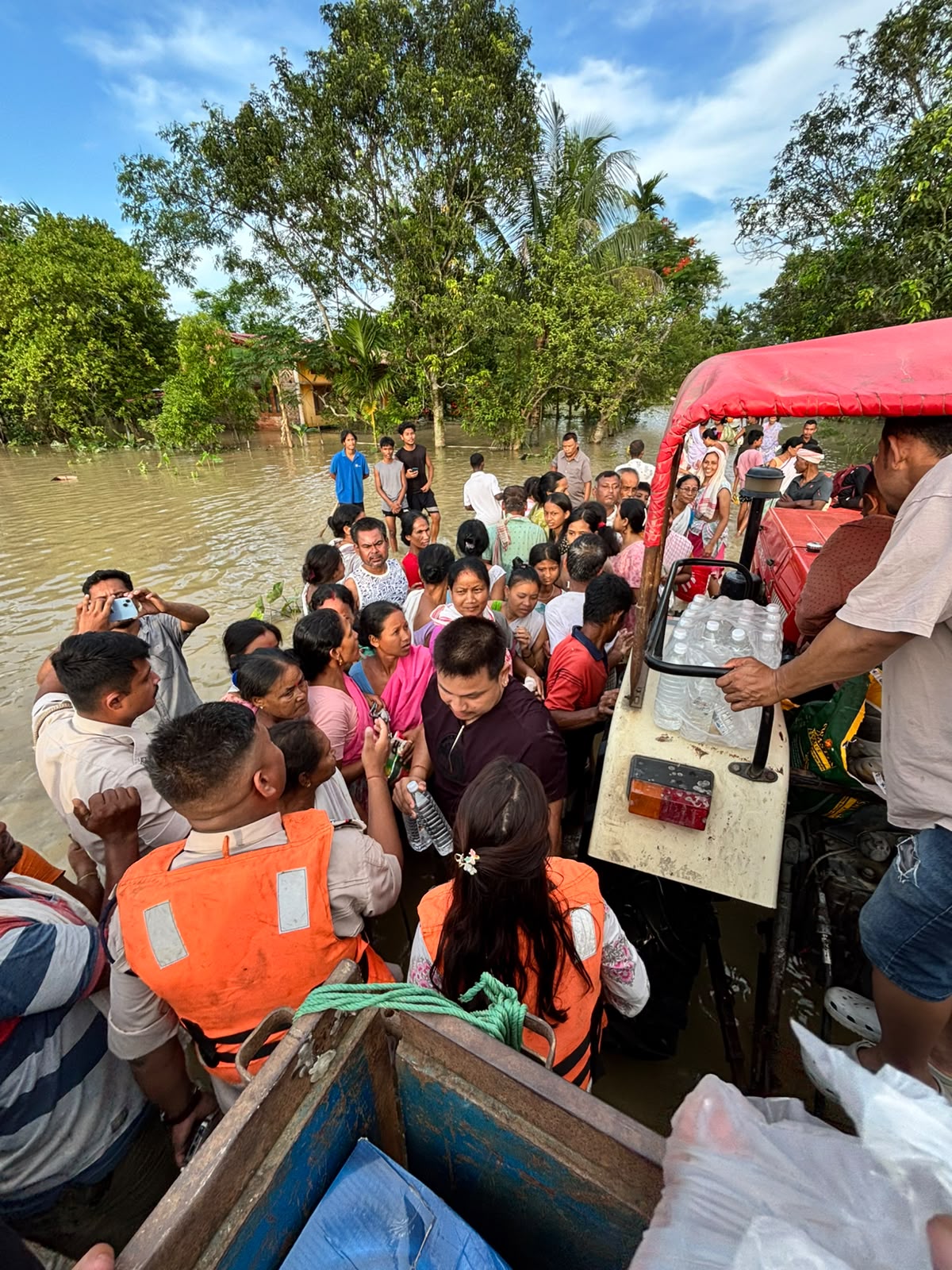 Volunteers distributing supplies to a gathered community
