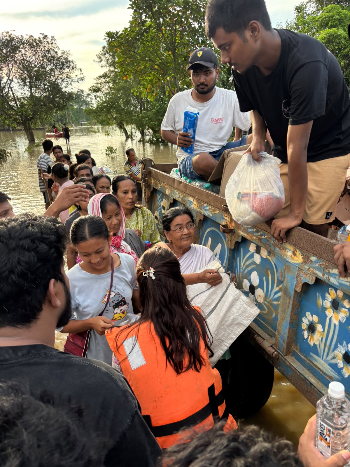 Volunteers handing relief supplies from a vehicle
